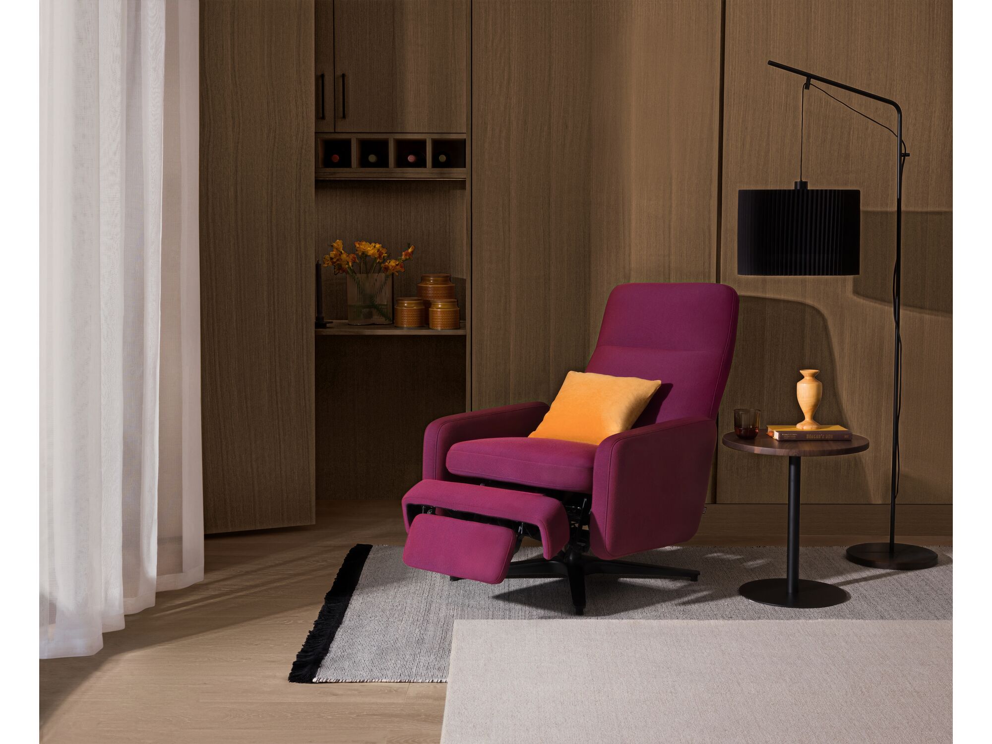 Purple reclining chair with orange accent pillow in wood paneled living space